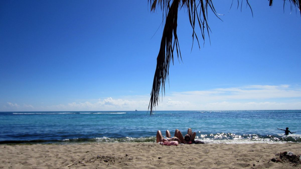 Beach goers sunbathing