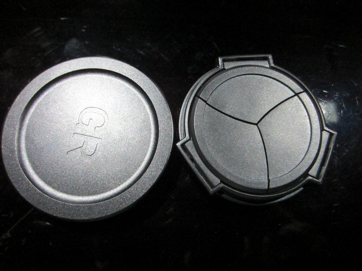 Auto lens cap has a smaller diameter because it screws onto the camera itself.